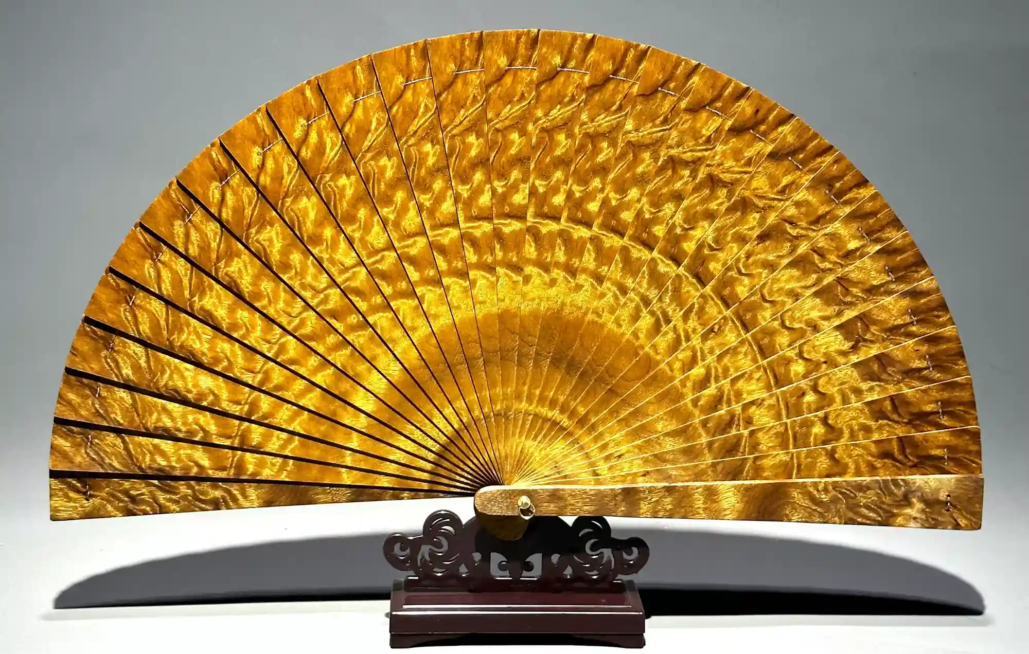 Crafting traditional Chinese hand fans, featuring silk and elegant folding designs.